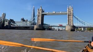 Rowing boat approaching Thames bridge